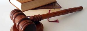 Judge's hammer and legal books