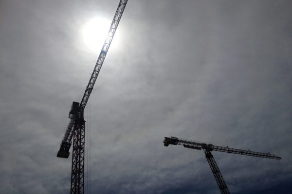 Construction cranes against the sky